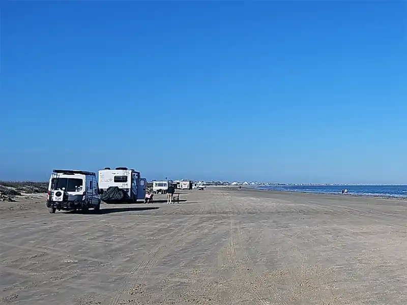Photo of vans and rvs camping at bolivar flats beach texas