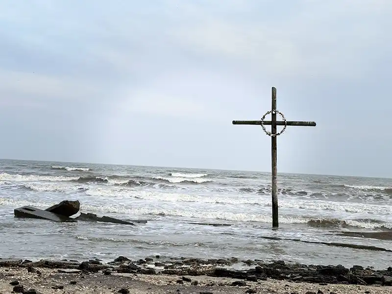 Photo of the cross in the water at high island beach texas